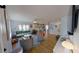Open-concept living room with hardwood floors, modern furniture, and a seamless flow to the kitchen at 1200 47Th St N, St Petersburg, FL 33713