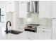 Modern kitchen features white cabinets, countertops, and stainless steel appliances and black hardware at 1218 E Kay St # 21, Tampa, FL 33602