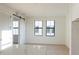 Open-concept living area featuring light wood floors, bright white walls, and a modern sliding barn door at 1218 E Kay St # 21, Tampa, FL 33602
