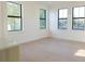 Bright living room with light wood floors and three large windows that let in plenty of natural light at 1218 E Kay St # 21, Tampa, FL 33602
