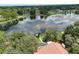 Expansive lake view from this aerial shot of a home with screened-in lanai at 12929 Sugar Creek Blvd, Hudson, FL 34669