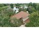 A beautiful aerial shot of a home with a brown roof and lakefront access at 12929 Sugar Creek Blvd, Hudson, FL 34669