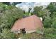 An aerial view of a home with a brown roof and waterfront access at 12929 Sugar Creek Blvd, Hudson, FL 34669