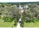 Aerial shot of a home with well manicured landscaping and a private driveway at 12929 Sugar Creek Blvd, Hudson, FL 34669