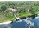 Aerial view of lakeside home with screened lanai and private boat dock at 12929 Sugar Creek Blvd, Hudson, FL 34669
