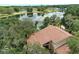 A captivating aerial view of a home with a brown roof and beautiful lake access at 12929 Sugar Creek Blvd, Hudson, FL 34669