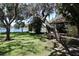 Spacious backyard featuring large trees with lake views at 12929 Sugar Creek Blvd, Hudson, FL 34669