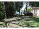 Large backyard featuring mature trees, trailers, and a partial view of the lake at 12929 Sugar Creek Blvd, Hudson, FL 34669