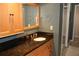 Bathroom vanity with black granite countertop and wood framed mirror at 12929 Sugar Creek Blvd, Hudson, FL 34669