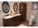 Bathroom boasts double sinks with vanity, a large linen closet and toilet at 12929 Sugar Creek Blvd, Hudson, FL 34669