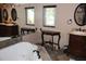 Bathroom featuring dual vanities, framed mirrors, a soaking tub with tile surround and neutral toned walls at 12929 Sugar Creek Blvd, Hudson, FL 34669