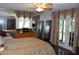 Bedroom features decorative curtains, a dresser, standing mirrors and a four poster bed at 12929 Sugar Creek Blvd, Hudson, FL 34669