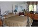 Bedroom featuring a decorative bed frame, ornate lamps and patterned wallpaper at 12929 Sugar Creek Blvd, Hudson, FL 34669