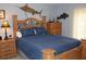 Bedroom boasts a decorative headboard, matching nightstands and unique wall decorations at 12929 Sugar Creek Blvd, Hudson, FL 34669