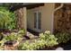 Exterior patio area with stone accents, lush greenery and plants at 12929 Sugar Creek Blvd, Hudson, FL 34669