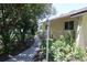 Landscaped walkway leading to the side of the house at 12929 Sugar Creek Blvd, Hudson, FL 34669