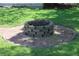 A cozy brick fire pit sits on a brick patio in the yard at 12929 Sugar Creek Blvd, Hudson, FL 34669