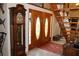 Home foyer featuring wood double entry doors, staircase, and tile flooring at 12929 Sugar Creek Blvd, Hudson, FL 34669