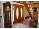 Home foyer featuring wood double entry doors, staircase, and tile flooring at 12929 Sugar Creek Blvd, Hudson, FL 34669