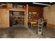 Garage space featuring built-in shelving, cabinets, and a workbench at 12929 Sugar Creek Blvd, Hudson, FL 34669