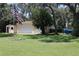Exterior of garage showing manicured lawn and an American flag at 12929 Sugar Creek Blvd, Hudson, FL 34669