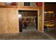 The garage featuring built-in shelving, workbench, and storage at 12929 Sugar Creek Blvd, Hudson, FL 34669