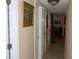 Hallway featuring multiple doors and neutral paint at 12929 Sugar Creek Blvd, Hudson, FL 34669