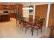 Kitchen with dining table, wood cabinets, and stainless steel refrigerator at 12929 Sugar Creek Blvd, Hudson, FL 34669