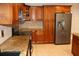 Kitchen featuring wood cabinets, granite counters, and stainless steel appliances at 12929 Sugar Creek Blvd, Hudson, FL 34669