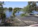 Expansive lake view featuring a private dock, seen through screened-in patio at 12929 Sugar Creek Blvd, Hudson, FL 34669