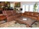 Comfortable living space with leather sofas, large windows, and access to the outdoors at 12929 Sugar Creek Blvd, Hudson, FL 34669