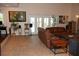 Inviting living room with comfortable leather seating and access to the outdoor space at 12929 Sugar Creek Blvd, Hudson, FL 34669