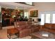 Relaxing living room with leather seating, a music room overlook and view to outdoor space at 12929 Sugar Creek Blvd, Hudson, FL 34669