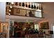 Unique living room features high ceilings, a loft area, and guitars displayed as decor at 12929 Sugar Creek Blvd, Hudson, FL 34669