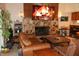 Cozy living room features a stone fireplace, plush leather furniture, and unique decor at 12929 Sugar Creek Blvd, Hudson, FL 34669