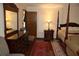 Main bedroom with wood floors, walk-in closet, four poster bed, rug, and ceiling fan at 12929 Sugar Creek Blvd, Hudson, FL 34669