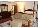 A sitting area highlights the main bedroom with it's four poster bed and dark wood dresser at 12929 Sugar Creek Blvd, Hudson, FL 34669