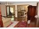 Main bedroom showcases hardwood floors, red patterned rug, sitting area, and mirrored closets at 12929 Sugar Creek Blvd, Hudson, FL 34669