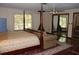 Spacious main bedroom featuring a four-poster bed, fireplace, and ample closet space at 12929 Sugar Creek Blvd, Hudson, FL 34669