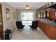 Cozy sitting room featuring access to the balcony overlooking the lake with a tranquil view at 12929 Sugar Creek Blvd, Hudson, FL 34669
