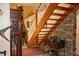 Wooden staircase featuring white spindles and stone accent wall at 12929 Sugar Creek Blvd, Hudson, FL 34669