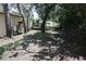 View of fenced in side yard with various potted plants at 12929 Sugar Creek Blvd, Hudson, FL 34669