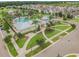 Aerial view of community clubhouse and pool area with lush landscaping and green lawns at 13311 Dorado Shores Ave, Riverview, FL 33579