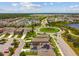 Stunning aerial view of a Primary-planned community featuring lush landscaping, roundabout, and community lake at 13311 Dorado Shores Ave, Riverview, FL 33579