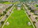 Aerial view of the community park with playground, gazebo, pool and long green field at 13311 Dorado Shores Ave, Riverview, FL 33579