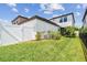 Spacious backyard with lush green grass, a white fence, and well-maintained landscaping at 13311 Dorado Shores Ave, Riverview, FL 33579