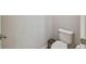 Small half bathroom with a white toilet and a grey trash can at 13311 Dorado Shores Ave, Riverview, FL 33579