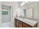 Bathroom with granite counters, wood cabinets and a large mirror at 13311 Dorado Shores Ave, Riverview, FL 33579