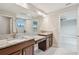 Bathroom features dual sinks with granite countertop, wood cabinets and large mirror at 13311 Dorado Shores Ave, Riverview, FL 33579