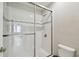 Bathroom features a glass door shower with tiled walls and shower head at 13311 Dorado Shores Ave, Riverview, FL 33579